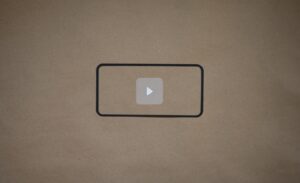 a video playing button on a piece of brown paper
